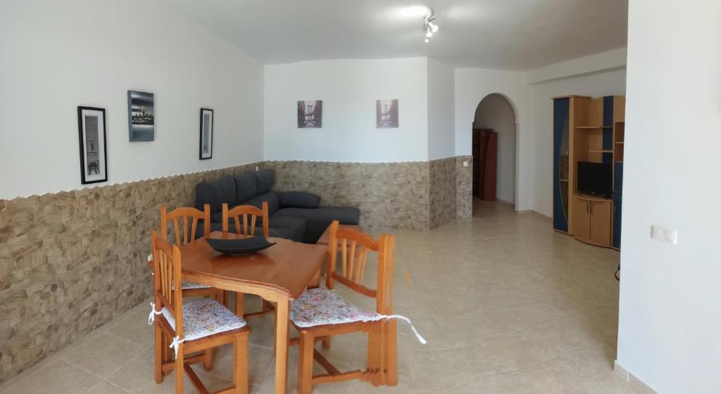 a living room with a table and chairs and a couch at GRANI MAR in Costa Calma