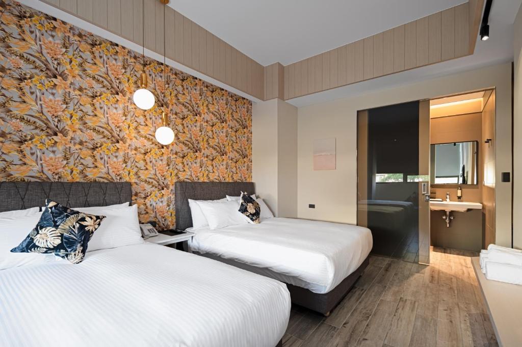 Postel nebo postele na pokoji v ubytování 森行旅 Mori Hotel -台南安平老街