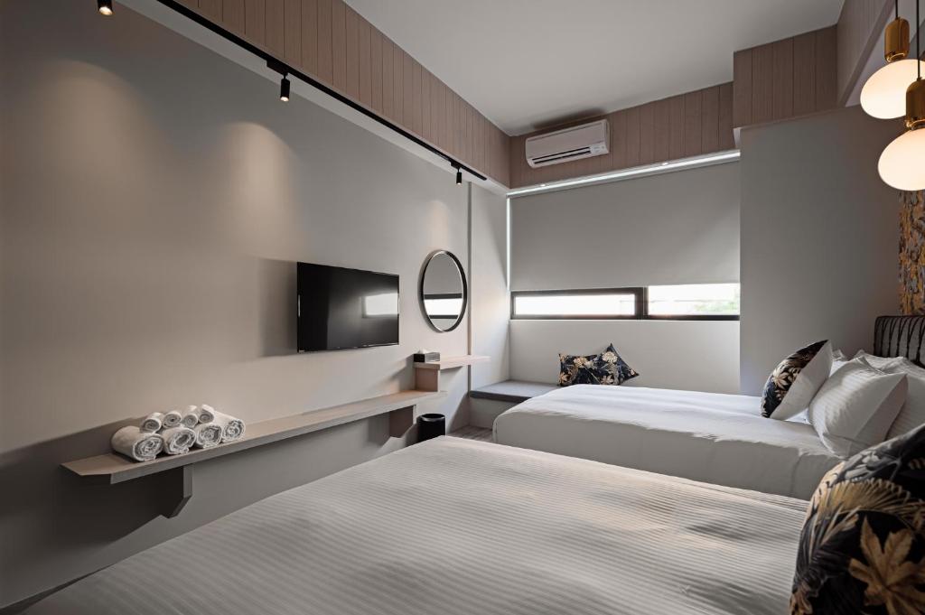 Postel nebo postele na pokoji v ubytování 森行旅 Mori Hotel -台南安平老街