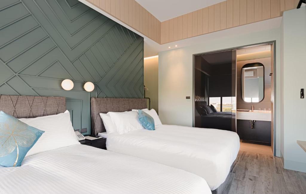 Postel nebo postele na pokoji v ubytování 森行旅 Mori Hotel -台南安平老街
