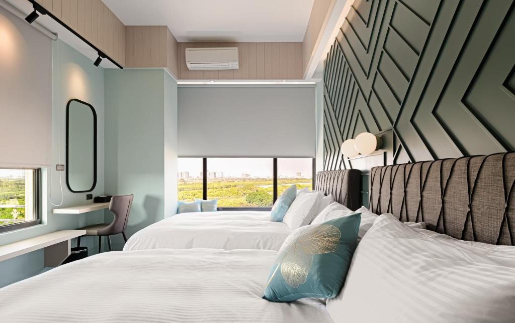 Postel nebo postele na pokoji v ubytování 森行旅 Mori Hotel -台南安平老街