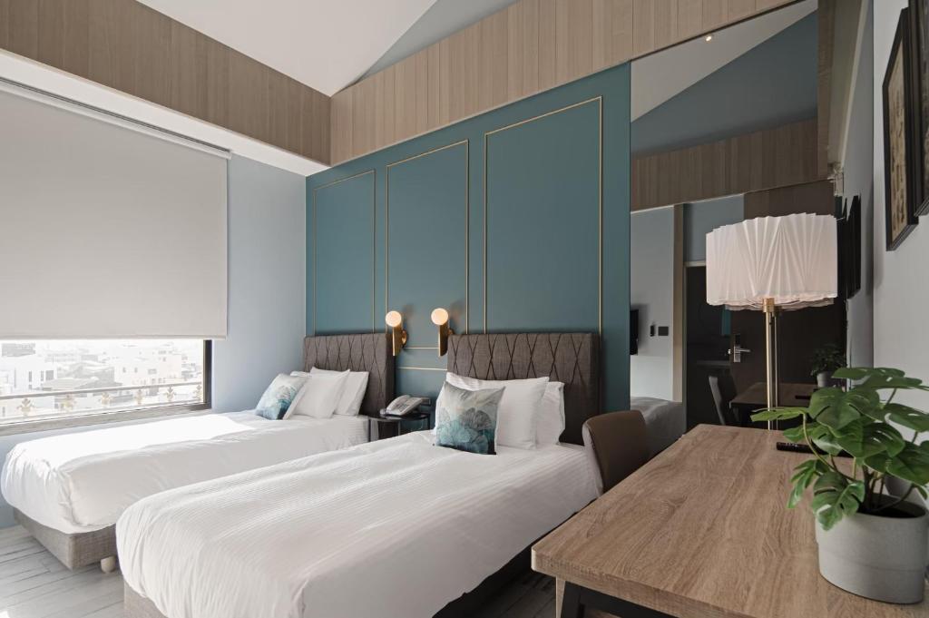 Postel nebo postele na pokoji v ubytování 森行旅 Mori Hotel -台南安平老街