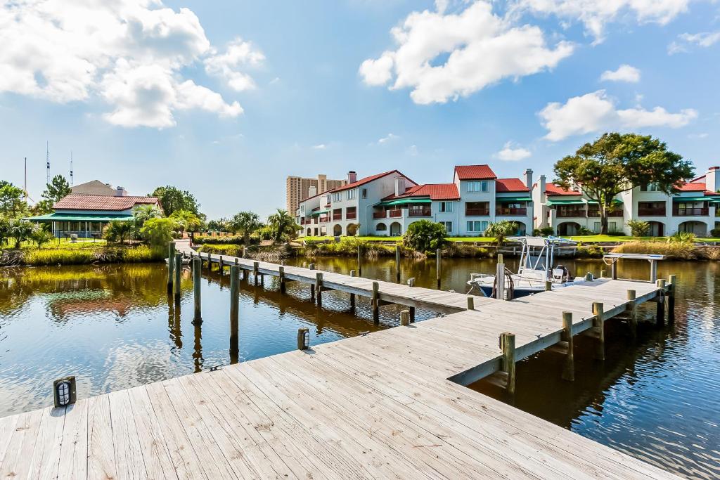 a dock with a marina and houses on the water at The Inn at St Thomas Square 1304A in Panama City Beach