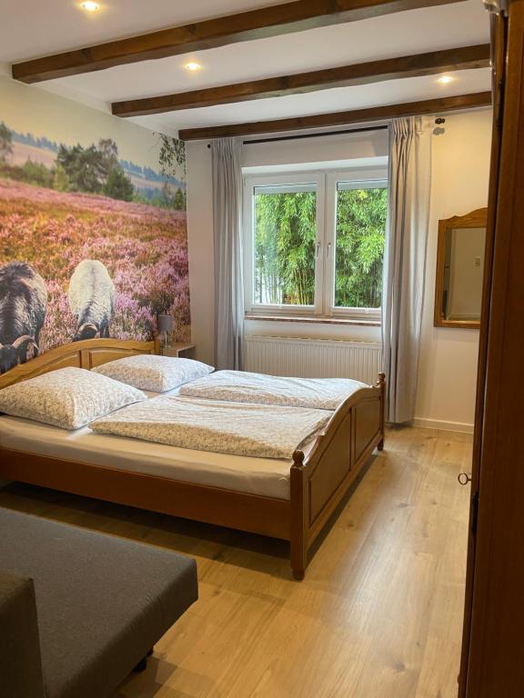 a bedroom with a bed and a window at Pension Rosenhof in Soltau