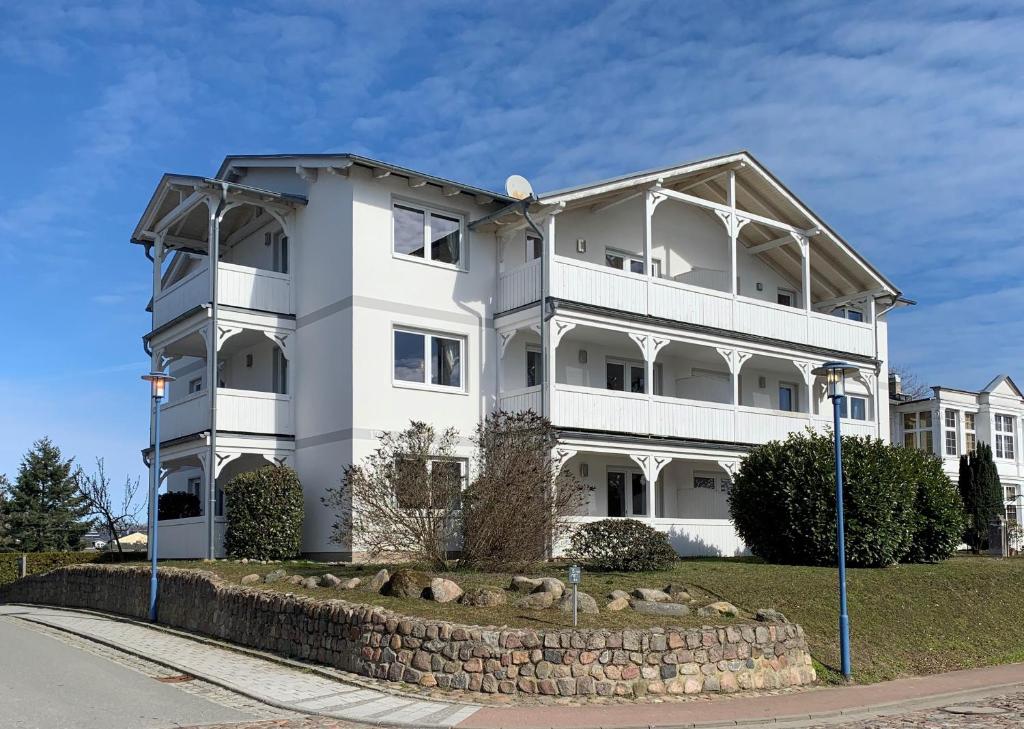 a large white building on the side of a street at Villa Fernsicht in Göhren