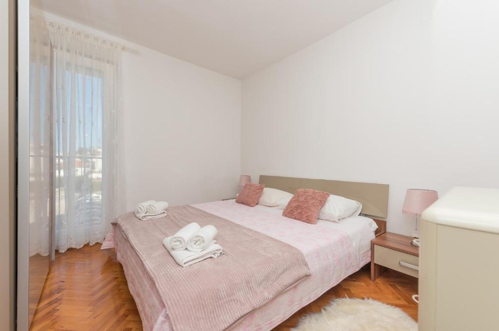 Posteľ alebo postele v izbe v ubytovaní Apartman Centar Glavaš