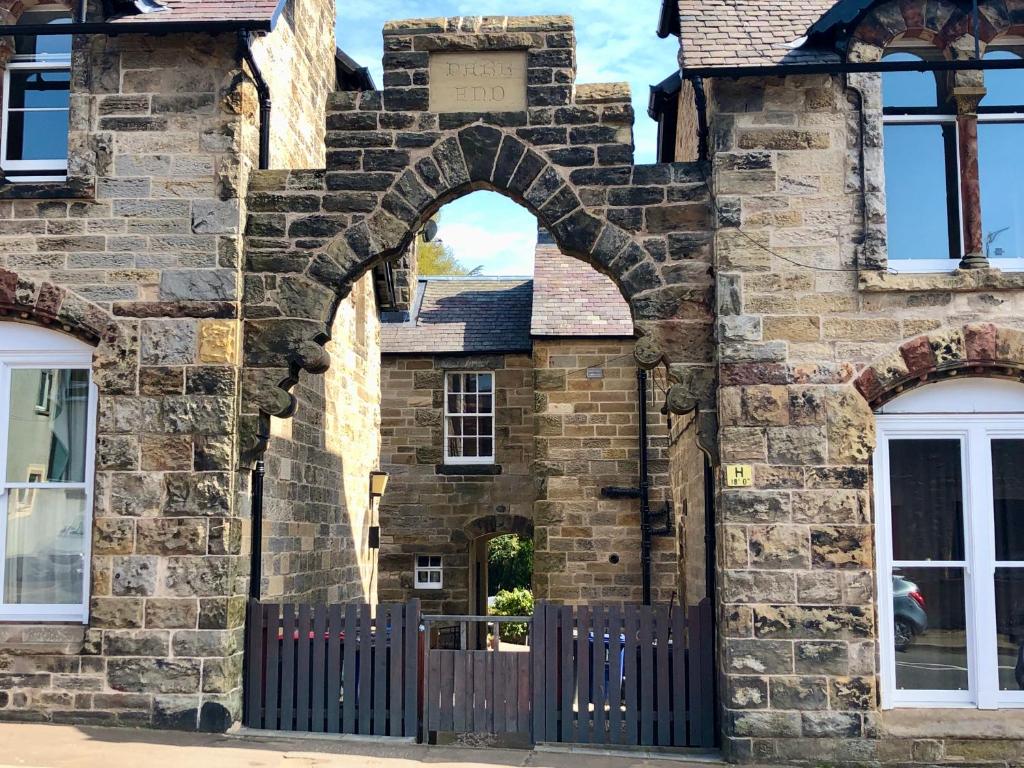 an entrance to a stone building with a gate at Underneath the Arches in Penicuik
