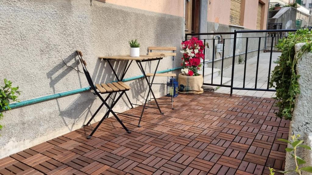 a table and chairs sitting on a balcony at LA CASETTA in Savona