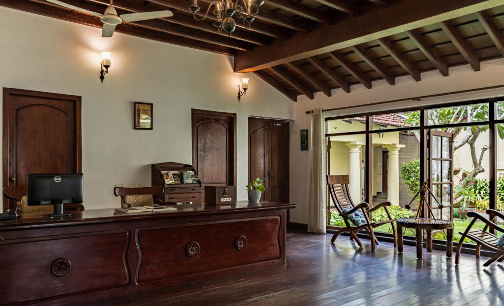 Heritage hotel room in Fort Kochi with colonial-era furniture — Kerala senior tour accommodation