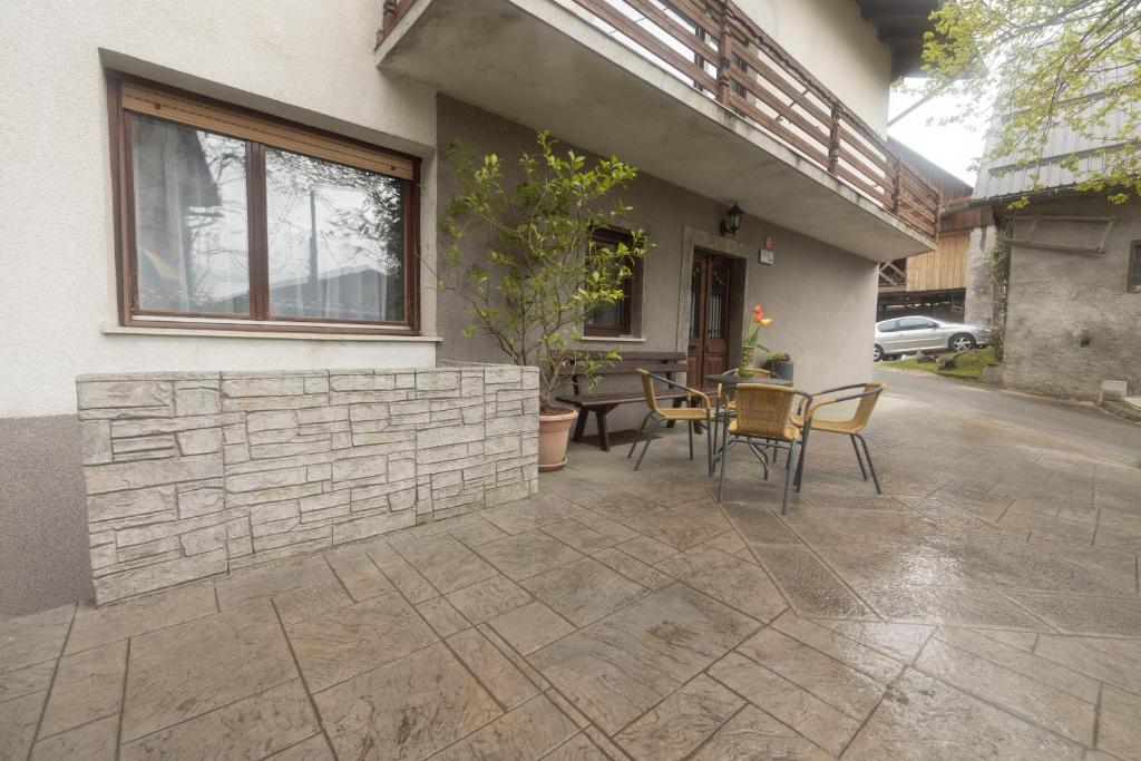 a patio with chairs and a table next to a building at Apartment Gaja in Tolmin