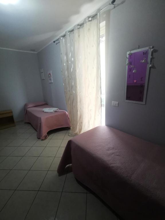 Posteľ alebo postele v izbe v ubytovaní Casa in Centro via gioeni
