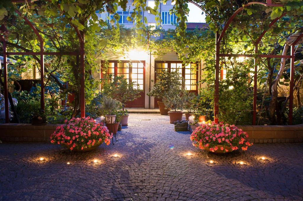 a garden with flowers and lights in a building at Casa Ganci in Turin