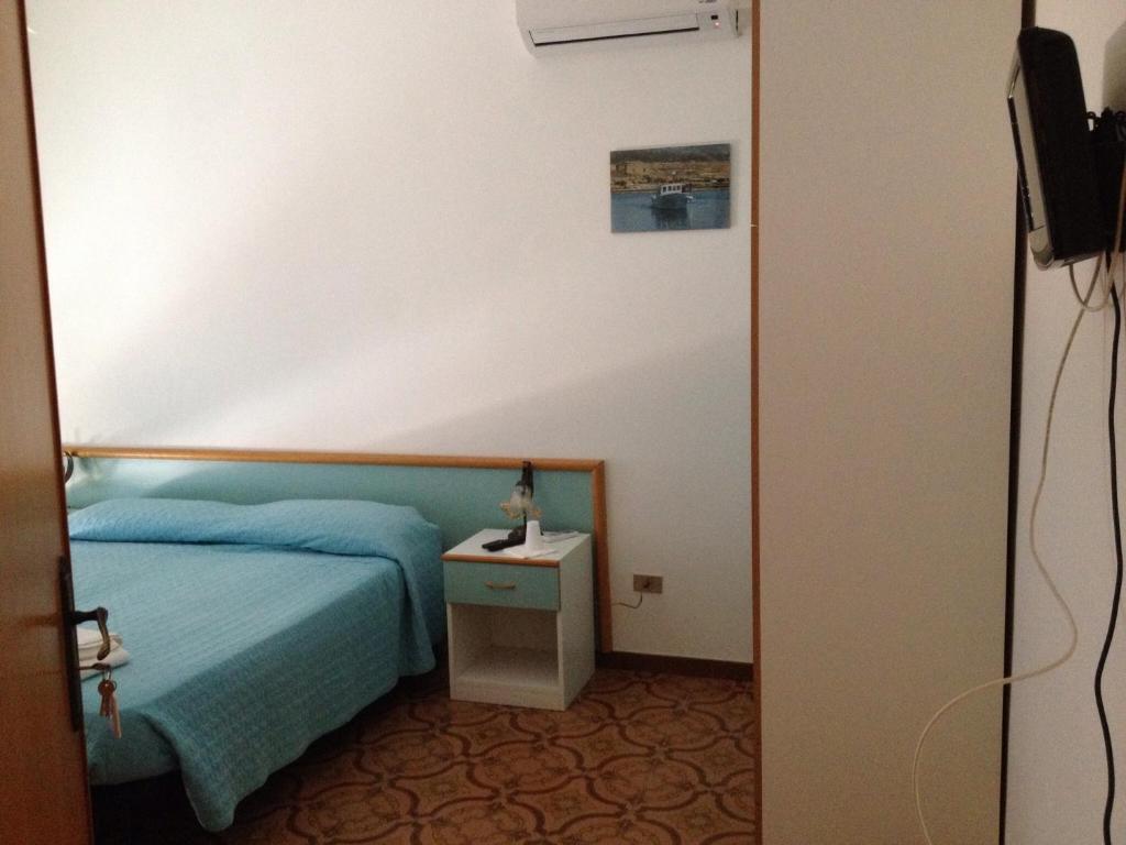 Postel nebo postele na pokoji v ubytování B&b La Scogliera