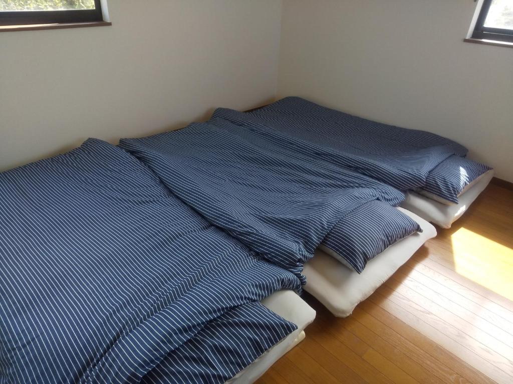 Postel nebo postele na pokoji v ubytování taiza house