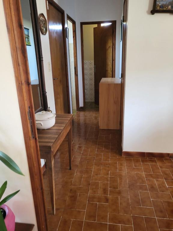 a hallway with a bathroom with a toilet and a table at Domaine du gros pata in Vaison-la-Romaine
