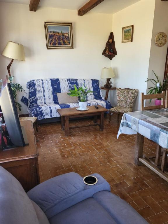 a living room with a couch and a table at Domaine du gros pata in Vaison-la-Romaine