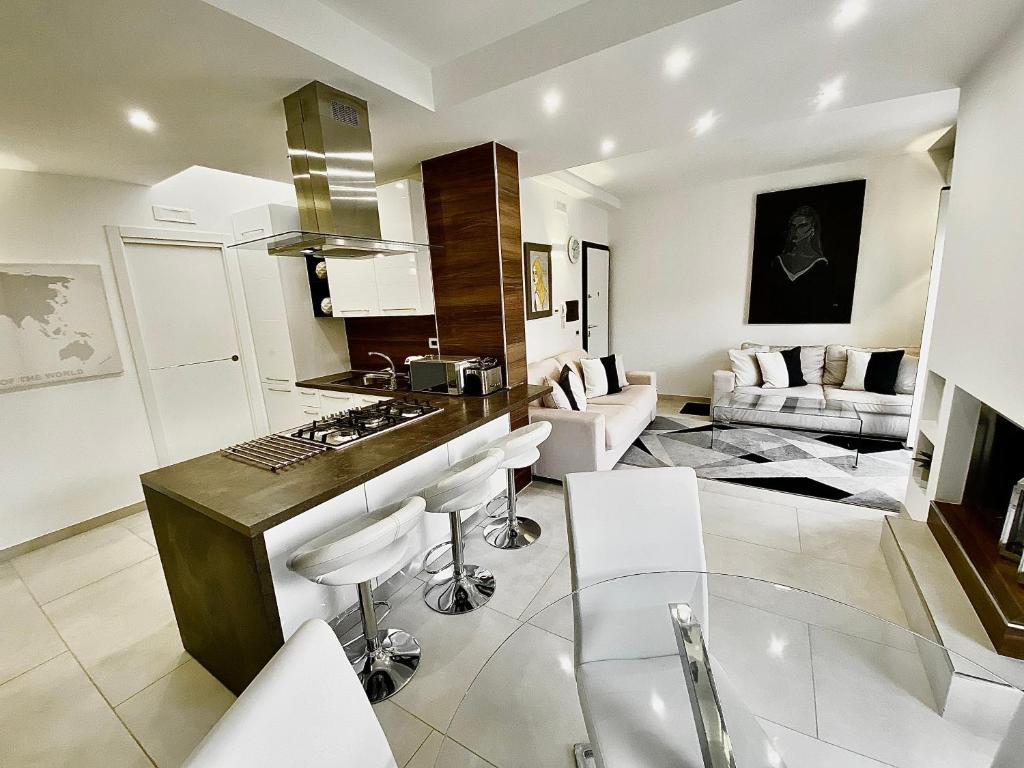 a kitchen and living room with a table and chairs at Mottola Apartment in Tropea