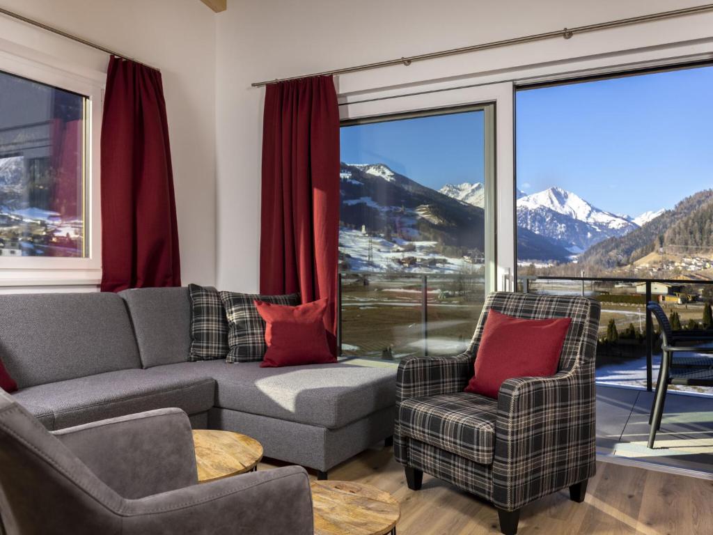 a living room with a couch and two chairs at Welcoming holiday home in Matrei in Osttirol with balcony in Matrei in Osttirol