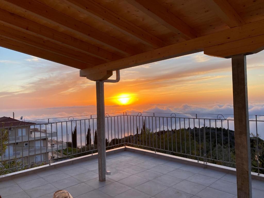 a view of the sunset from the balcony of a house at Aetos House Exanthia Village in Exanthia