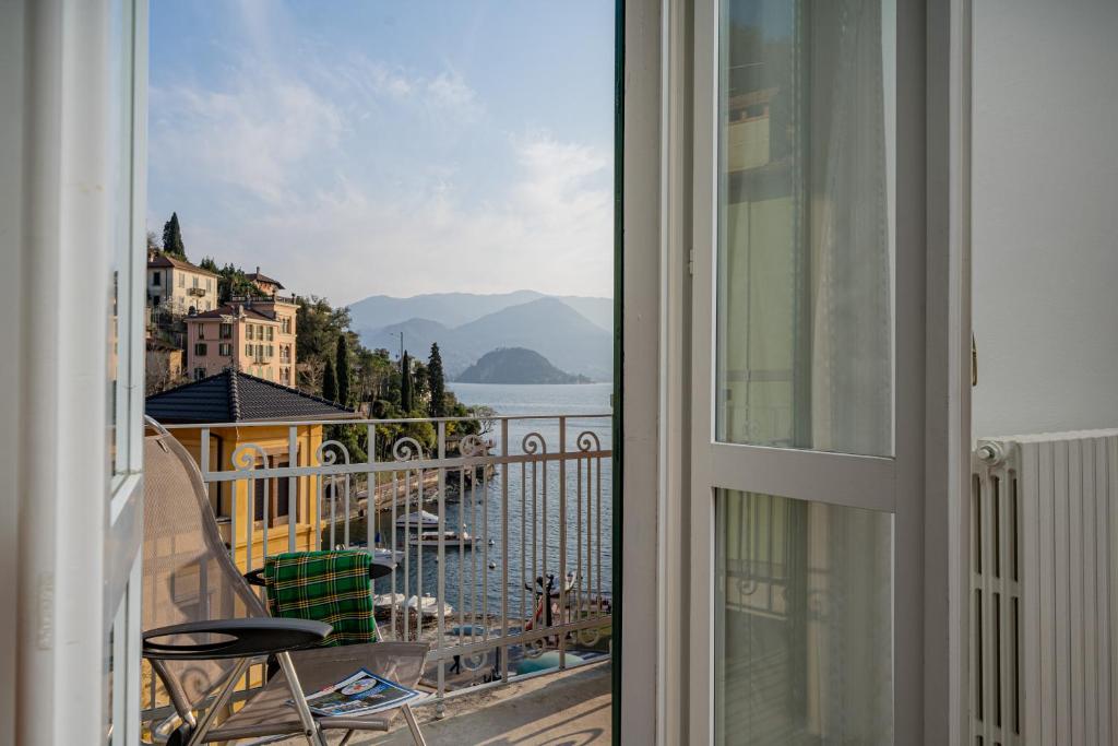 a balcony with a view of the water and buildings at Casa Sole in Varenna