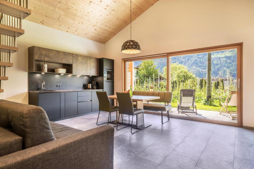 a kitchen and living room with a table and chairs at Pixnerhof Chalet Bonita in Ciardes