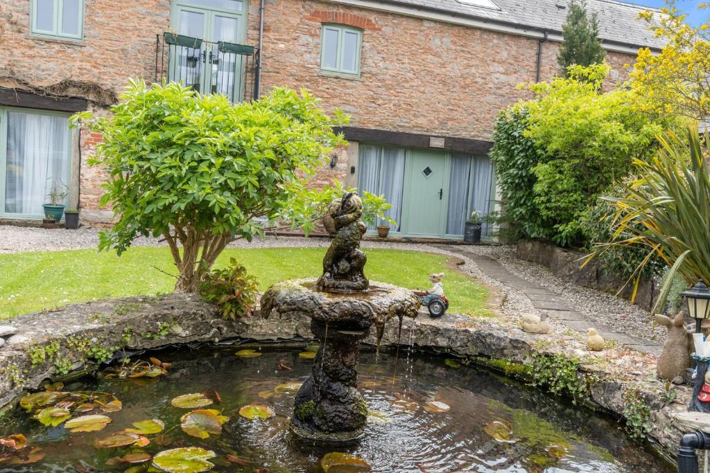 a koi pond in front of a house at The Old Mill in Paignton