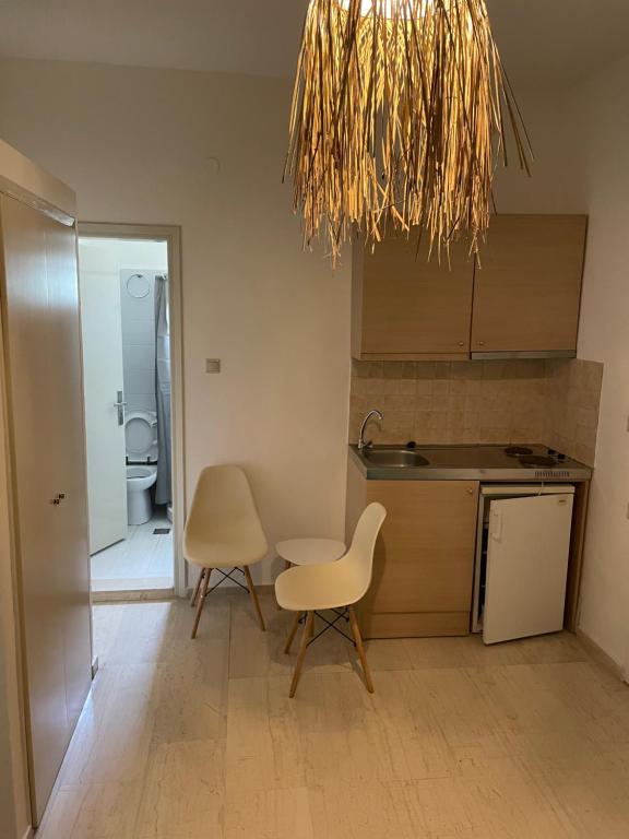 a kitchen with a sink and a table and chairs at Villa Sylvia in Matala
