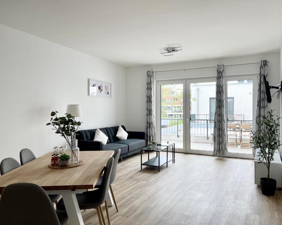 a living room with a table and a couch at Schöne Apartments in der Innenstadt von Osnabrück I home2share in Osnabrück