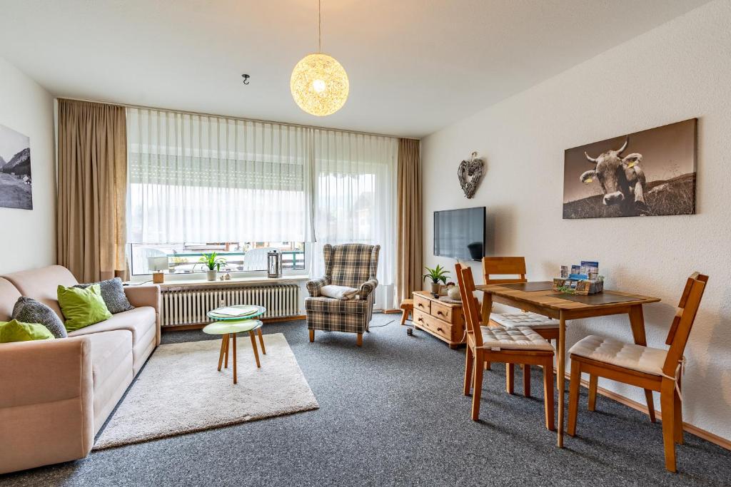 a living room with a couch and a table at Fischener Biberle in Fischen