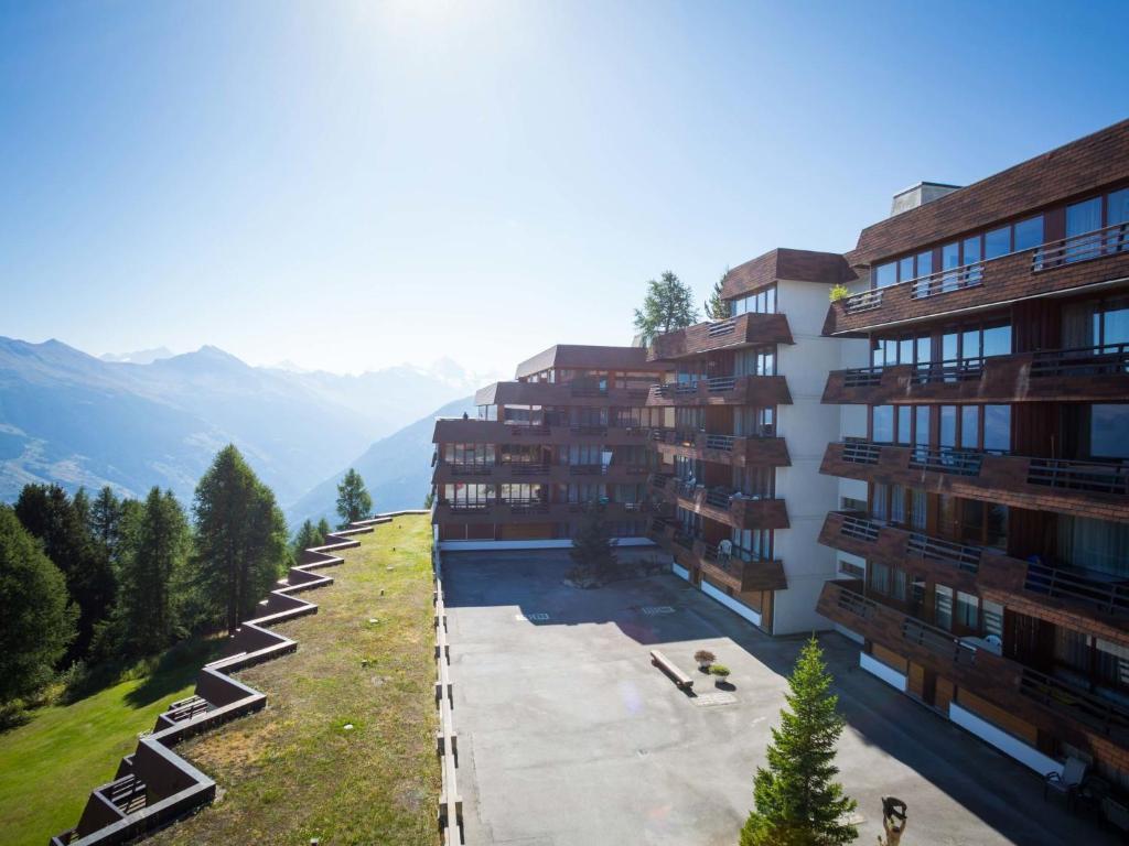 arial view of a building with mountains in the background at Apartment Wildhorn 322 by Interhome in Les Collons