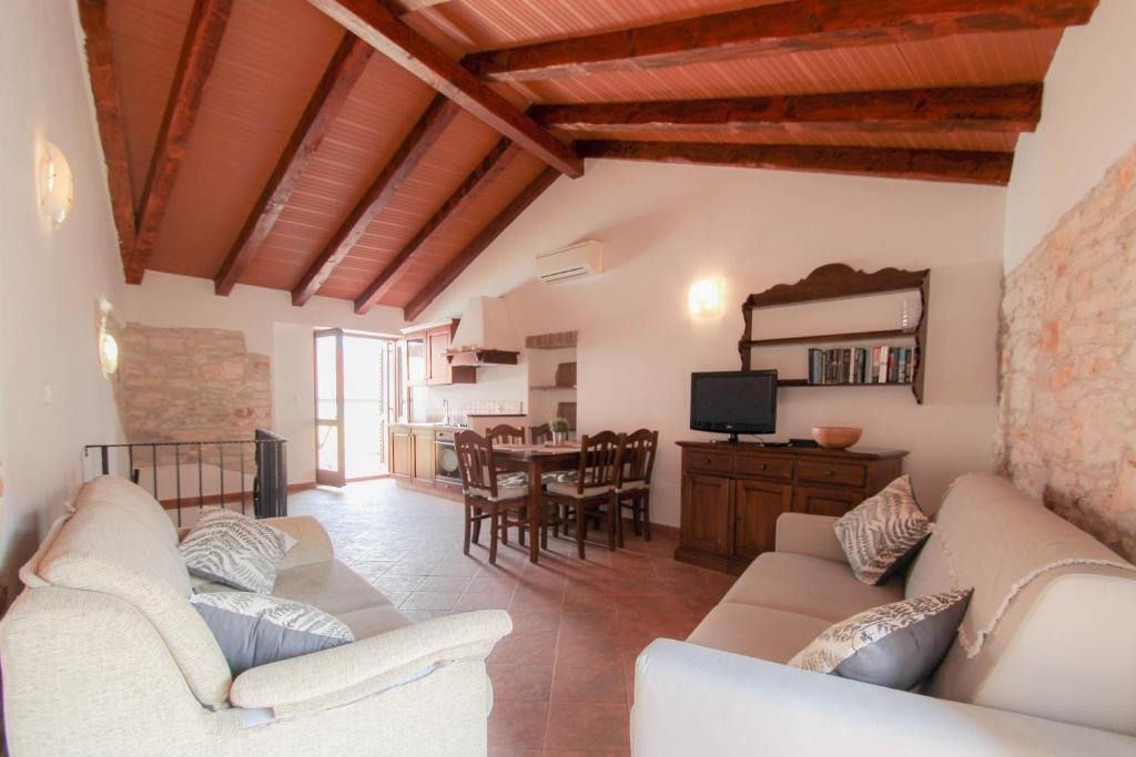 a living room with two couches and a dining room at Casa Ijana in Novigrad Istria