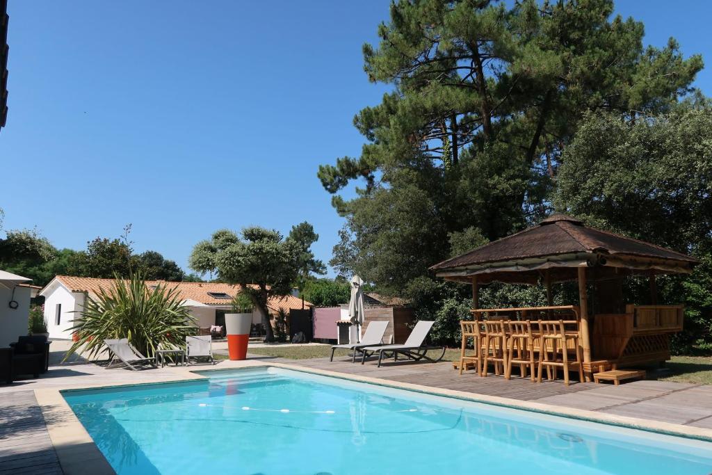 a swimming pool with a gazebo next to at Au K'Ré in Rivedoux-Plage