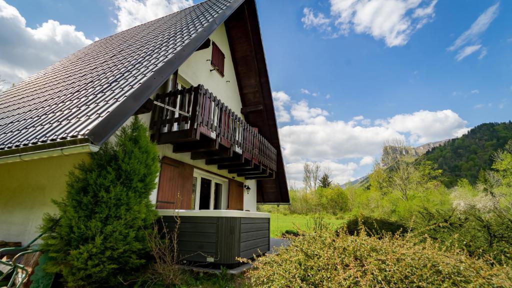 a building with a balcony on the side of it at Holiday home Riverside in Delnice