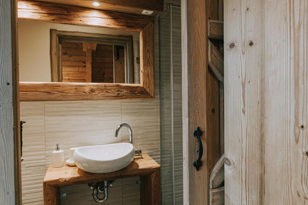 un bagno con un lavandino bianco e uno specchio di Hostel Lukna a Mojstrana