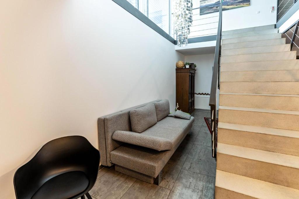 a living room with a chair and stairs at Apartment 3 in Rielasingen-Worblingen