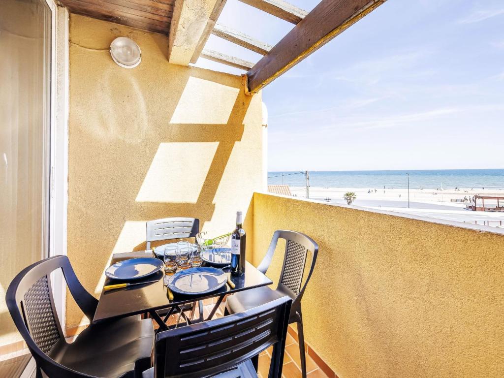 une table et des chaises sur un balcon avec vue sur la plage dans l'établissement Studio Les Balcons de la Méditerranée-36 by Interhome, à Narbonne-Plage