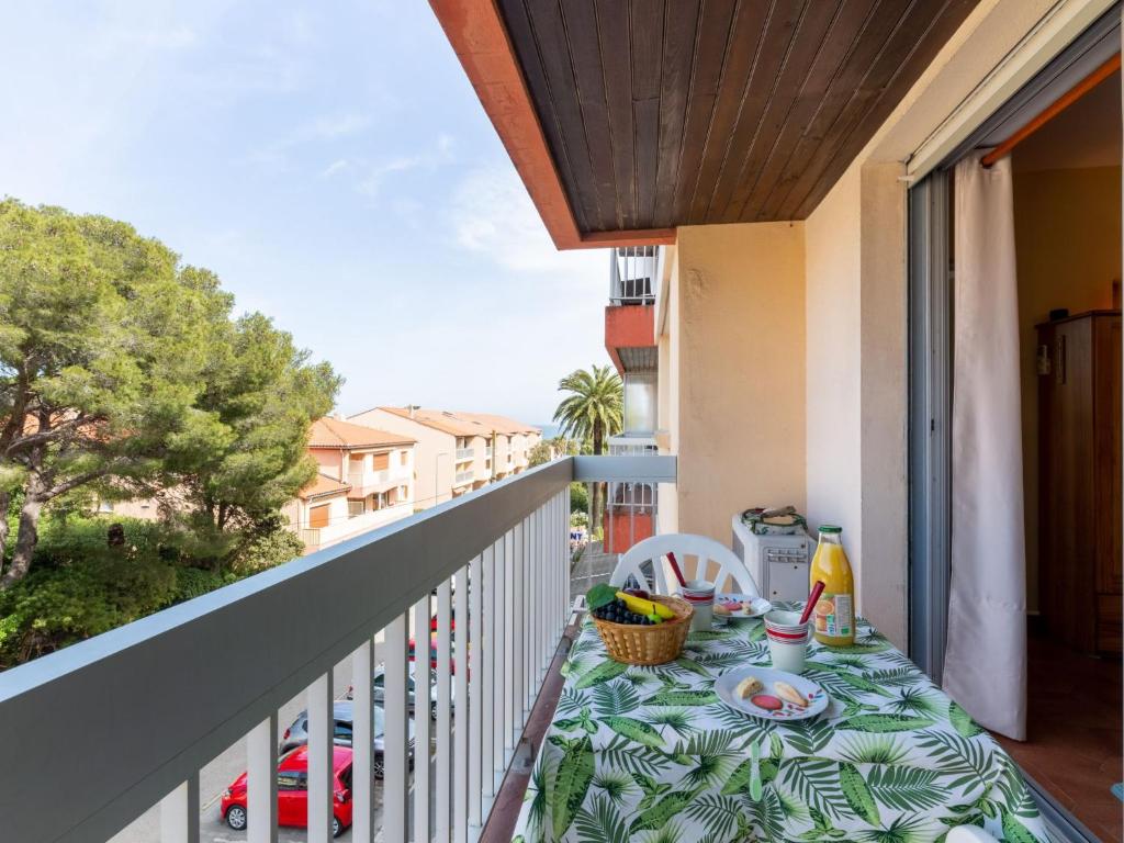 a table on a balcony with a table cloth on it at Apartment L'Espelido-5 by Interhome in Saint-Aygulf