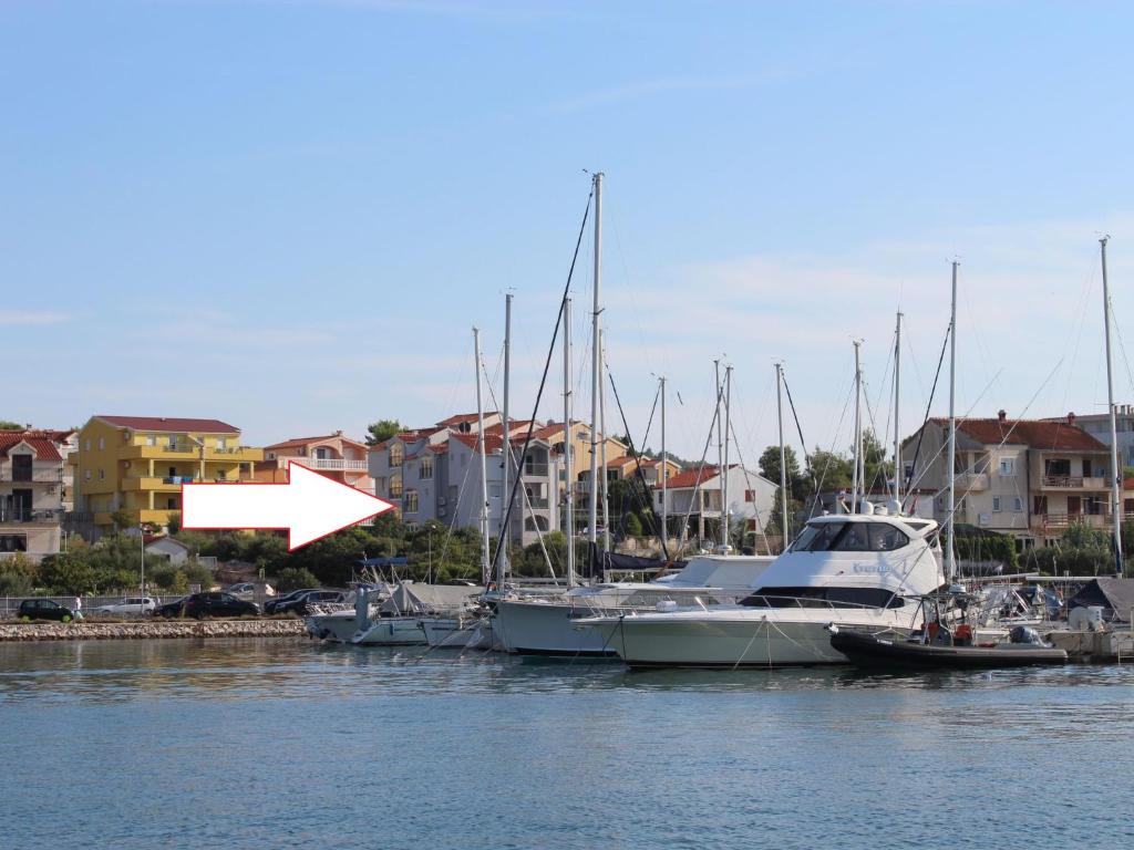 a group of boats docked in a harbor with buildings at Apartment Anna-3 by Interhome in Jezera