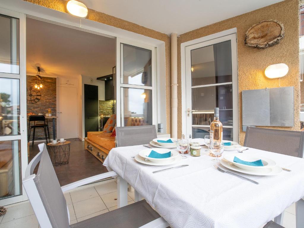 une salle à manger avec une table et des chaises blanches dans l'établissement Apartment L'Esquinade - J4236 by Interhome, à Agay
