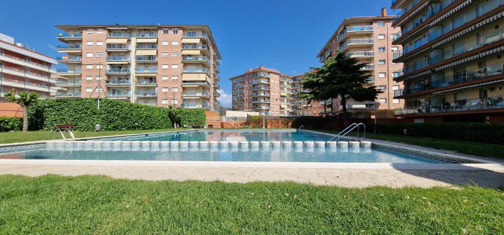 een zwembad in een stad met hoge gebouwen bij Vivalidays Luis in Santa Susanna