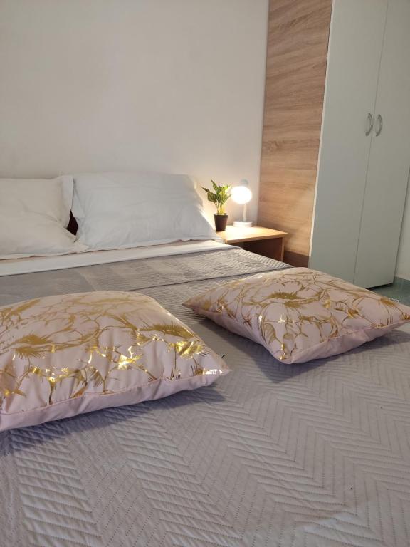 a bedroom with a bed with two pillows on it at Summer vibe in Vir