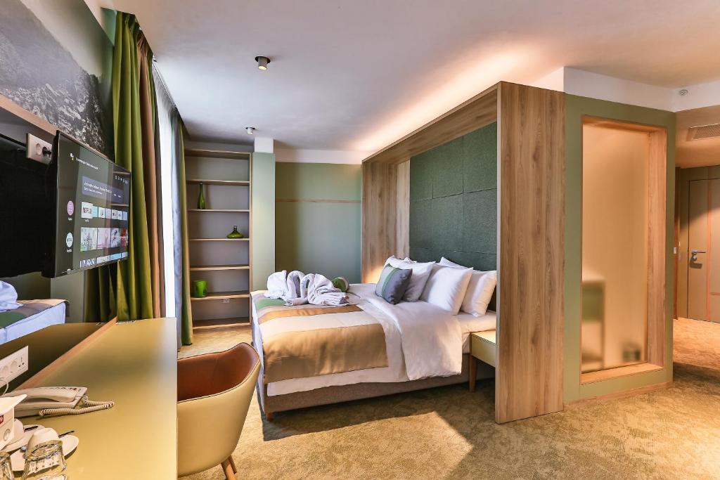Letto o letti in una camera di Carine Hotel Centar