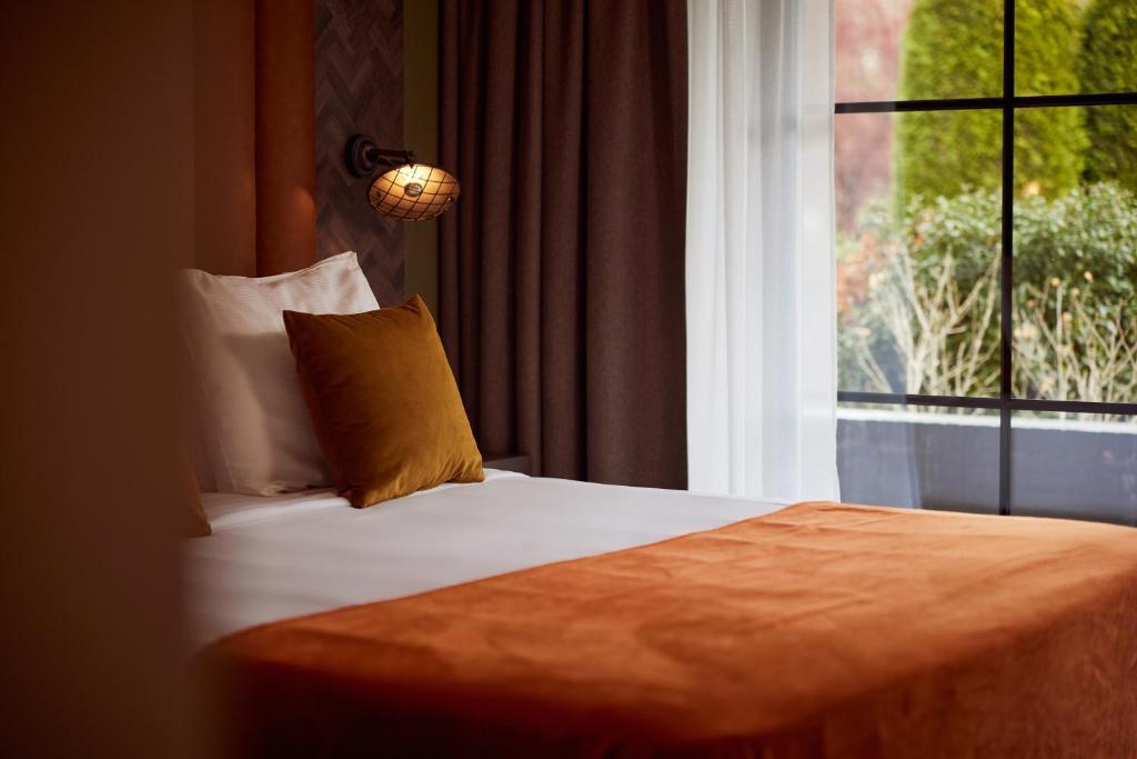 Postel nebo postele na pokoji v ubytování Van der Valk Hotel Dennenhof