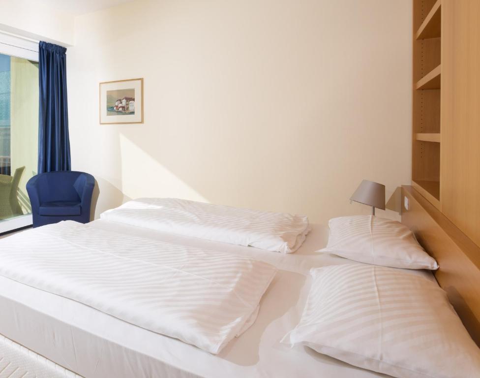 Postel nebo postele na pokoji v ubytování Hotel Maximilian