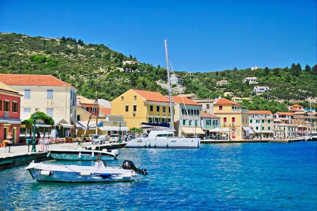 a group of boats docked in a harbor with buildings at Lili Luxury Cottage in Gaios