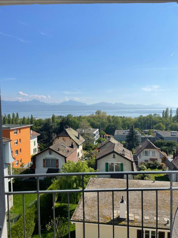 a view of a town from a balcony at Lake view Lausanne in Lausanne