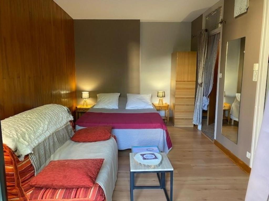 a hotel room with two beds and a table at Studio Brides-les-Bains, 1 pièce, 2 personnes - FR-1-512-253 in Brides-les-Bains