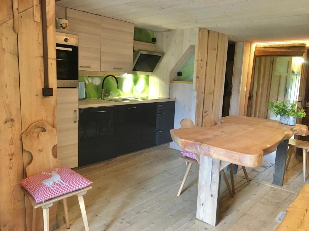 a kitchen with a wooden table in a room at Ferienhaus Ritter in Egg