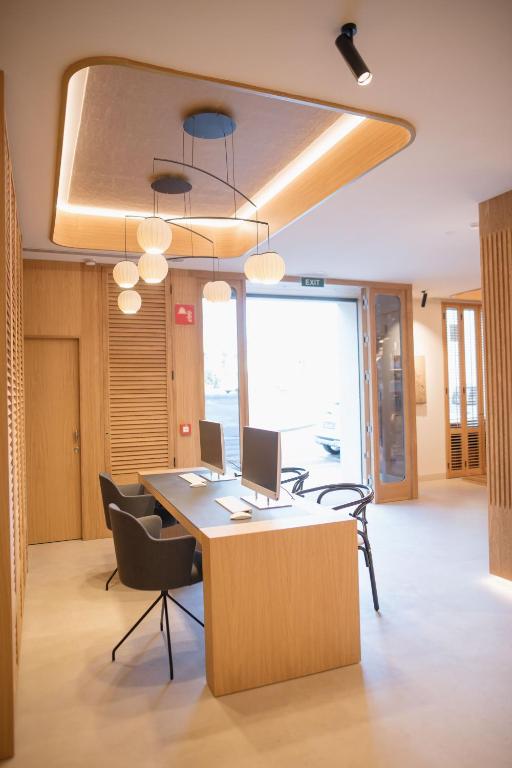 an office with a desk with two computers on it at MYR Puerta Serranos in Valencia