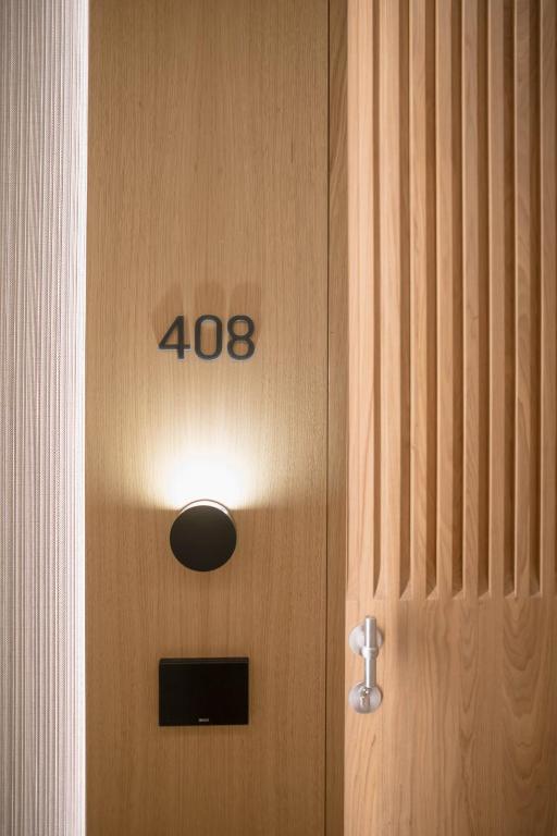 a wooden door with the number on it at MYR Puerta Serranos in Valencia